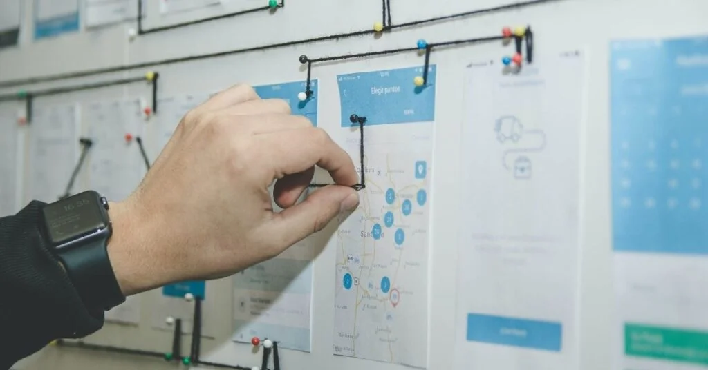 hand pulling string over UX/UI prototypes