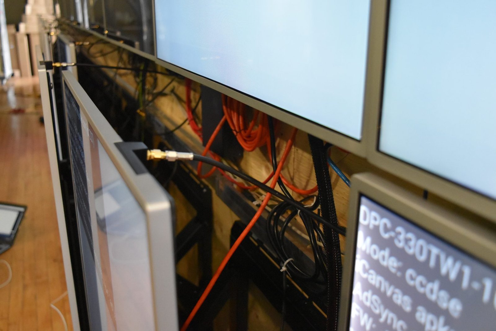 LCD Design and Commercial Integration at Scale: The ArcLight Cinemas StoryWall 10 LCD screen popped out on its mount showing the cabling behind the video wall