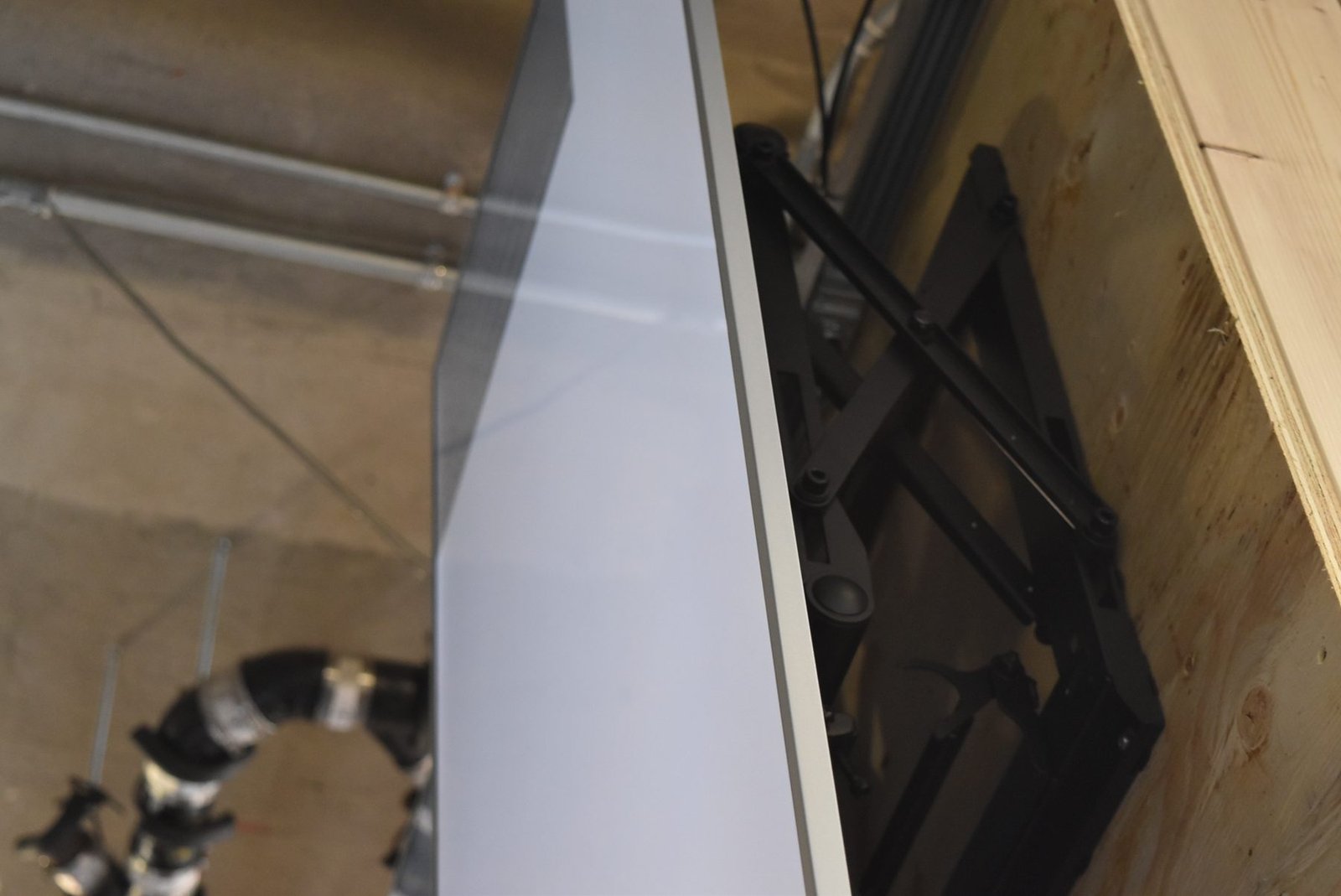 LCD Design and Commercial Integration at Scale: The ArcLight Cinemas StoryWall 11 Side view of a scissor-arm mount behind a portrait LCD screen