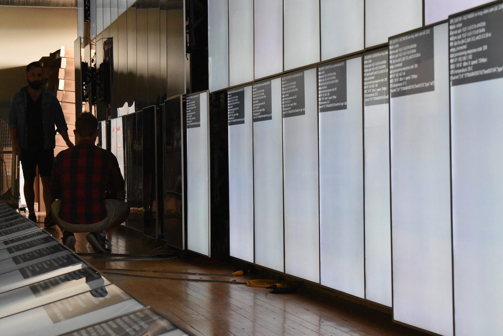 LCD Design and Commercial Integration at Scale: The ArcLight Cinemas StoryWall 7 Long run of portrait LCD screens with a few open positions during Montreal staging