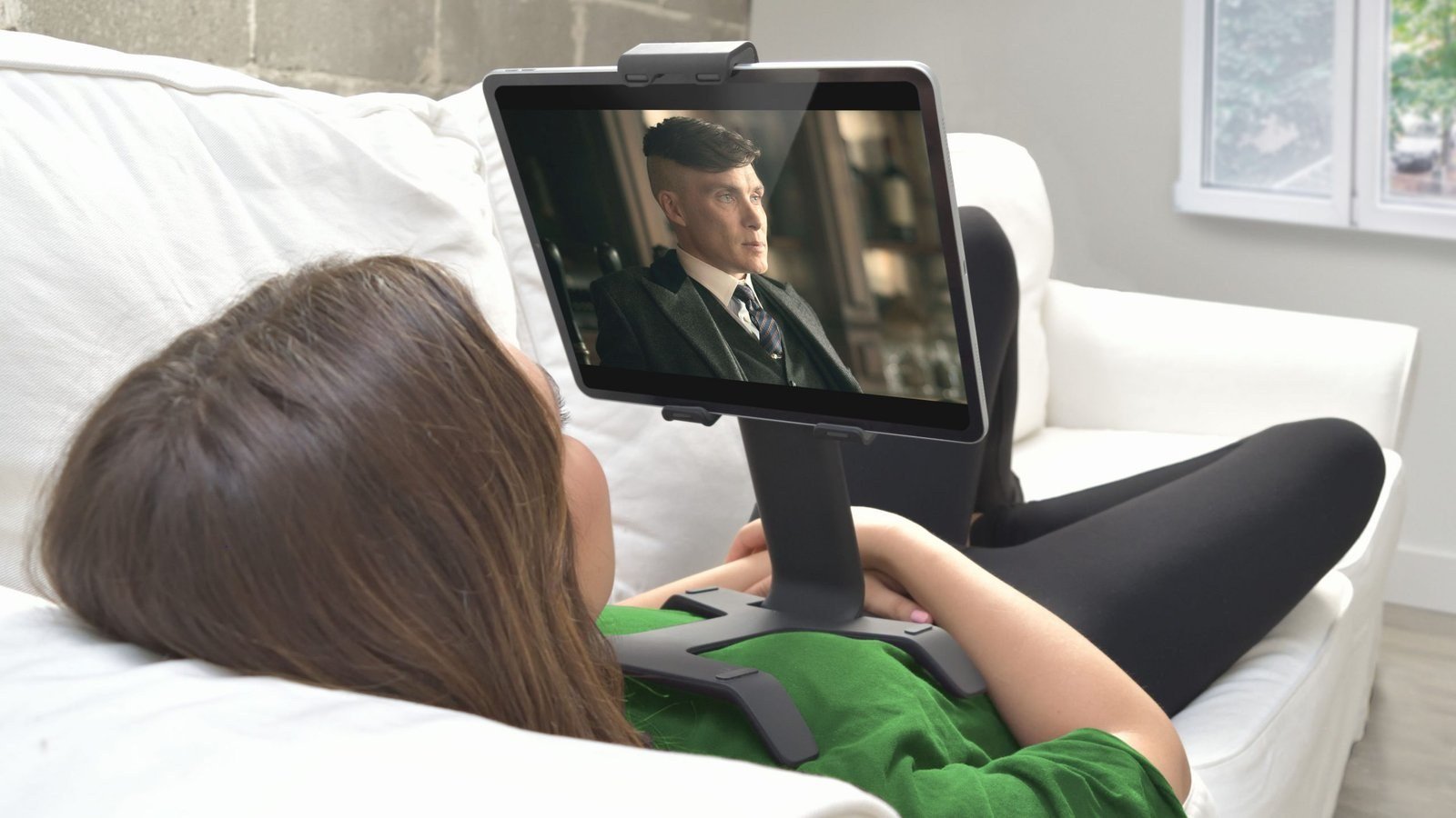 Product Design Challenges Behind the Tstand Base: Ergonomics, Sink Marks, Snap-Fits, and Lifters 2 Person lying on a sofa watching a show on a tablet held by Tstand
